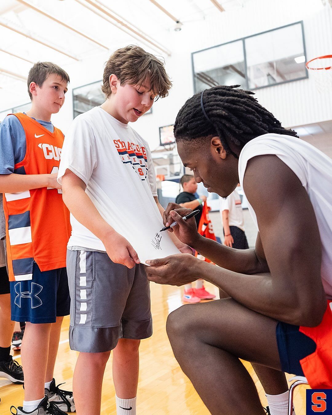 William Kyle III signs a young hooper's T-shirt (Image via Instagram @cuse_mbb)